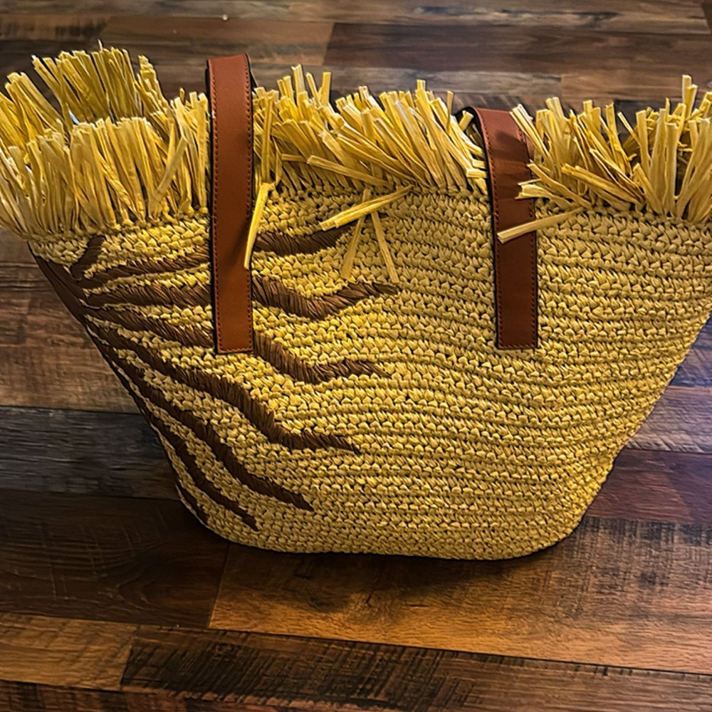 FARM Rio fringed woven tote bag in natural and brown with tan leather handles.